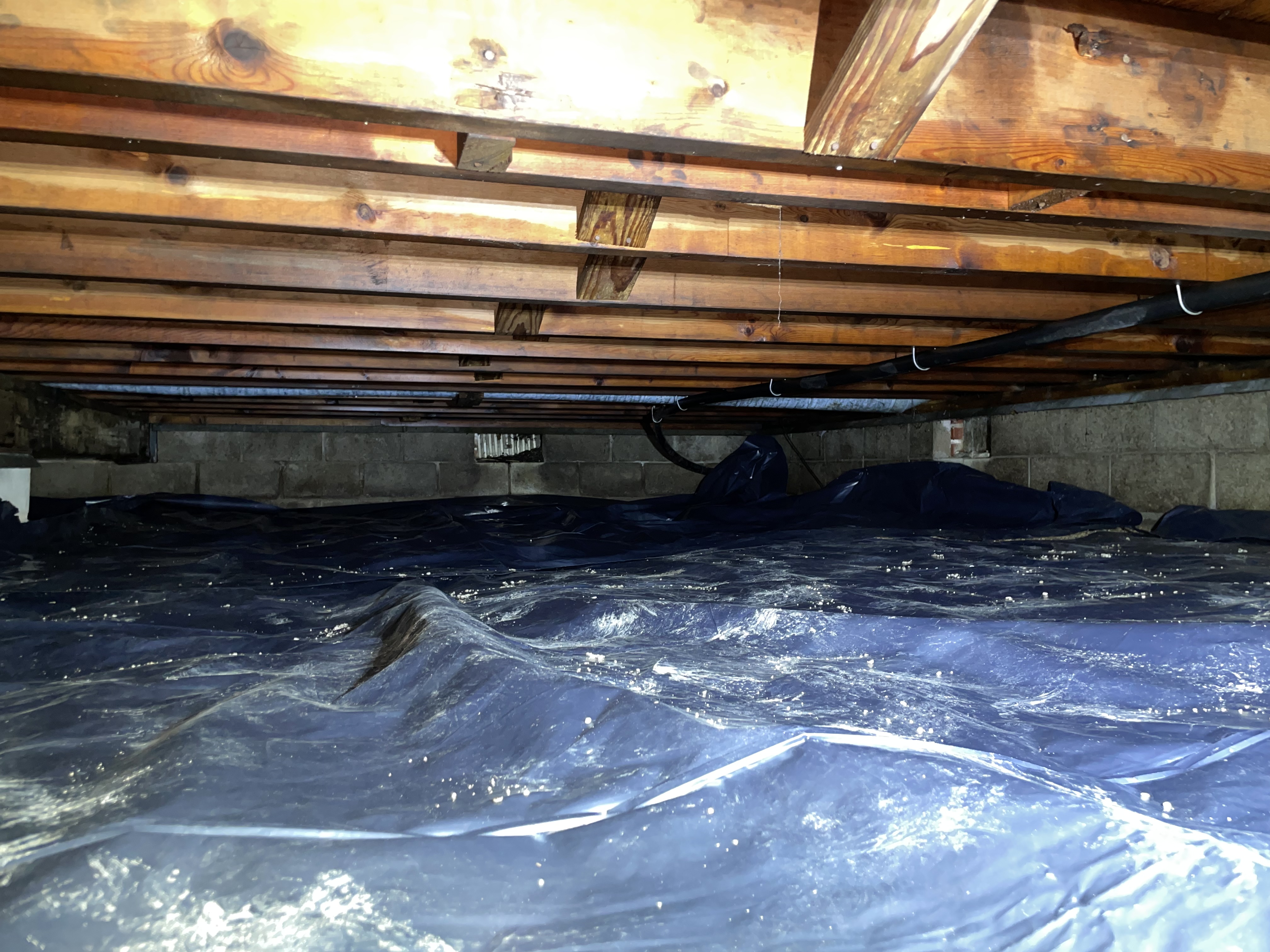 Crawl space after vapor barrier installation and encapsulation