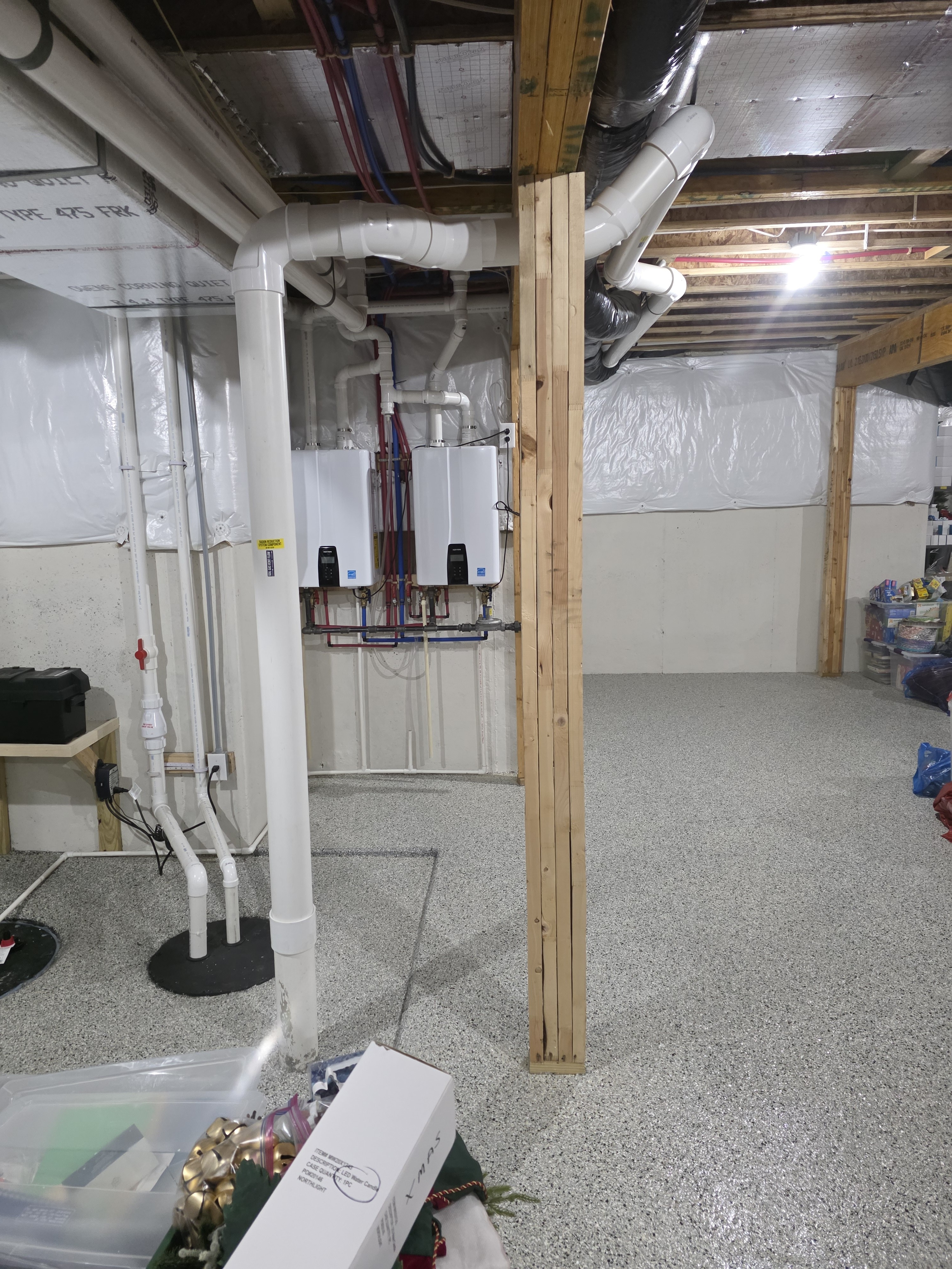 Radon mitigation system piping installed in basement