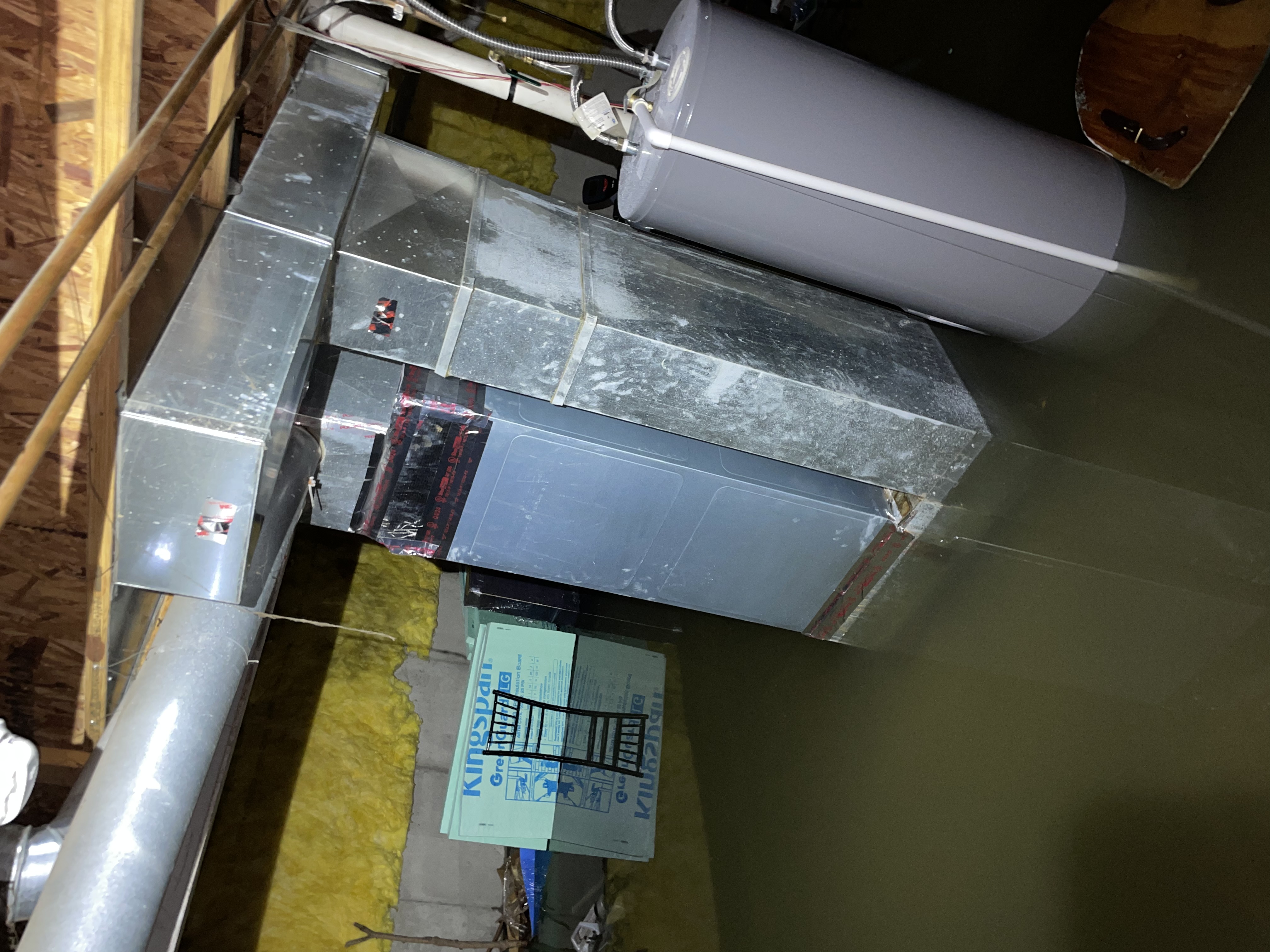 Standing water around HVAC equipment in a basement crawl space